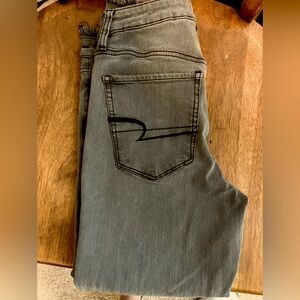 Distressed stretch jeans by American Eagle. Black distress, light wash. Size 4.